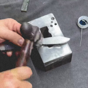 A RoseCraft Craftsman hammers the pins on each side of the bolster